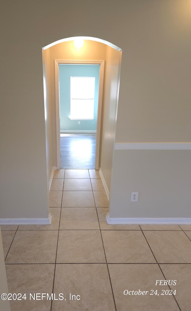 corridor with light tile patterned flooring