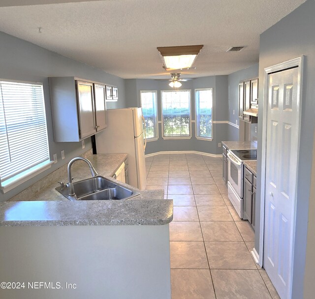 kitchen with ceiling fan, sink, light tile patterned floors, and white appliances