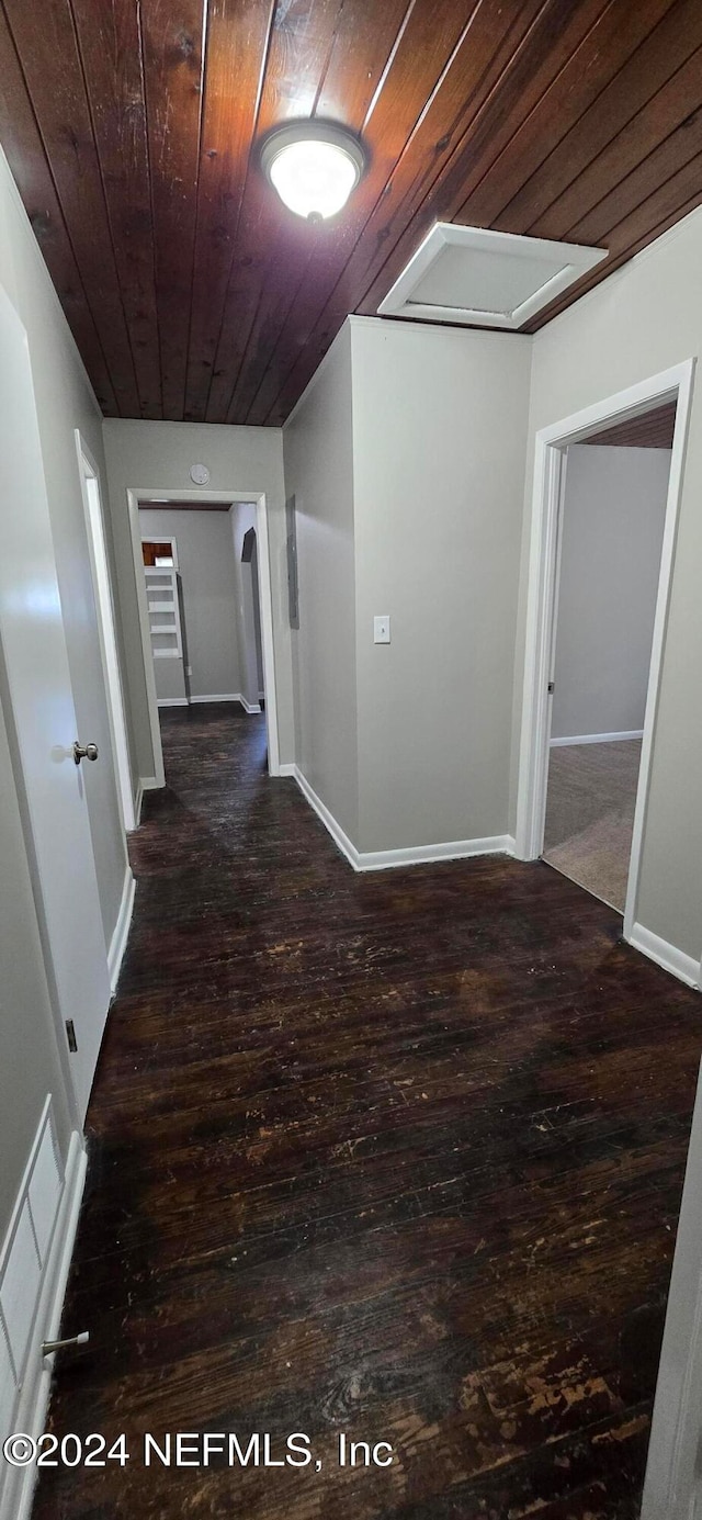 hallway with dark wood-type flooring and wood ceiling