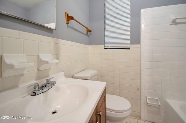 full bathroom featuring plus walk in shower, toilet, tile patterned flooring, vanity, and tile walls