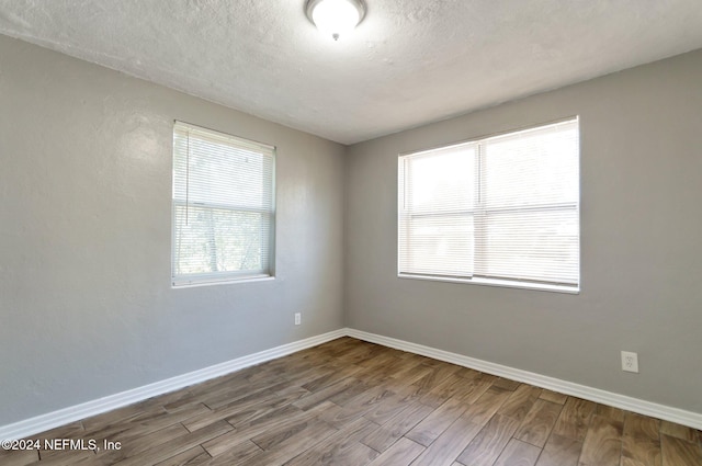 1526 W 14th St, Jacksonville, FL 32209 - empty room featuring baseboards, a textured ceiling, and wood finished floors