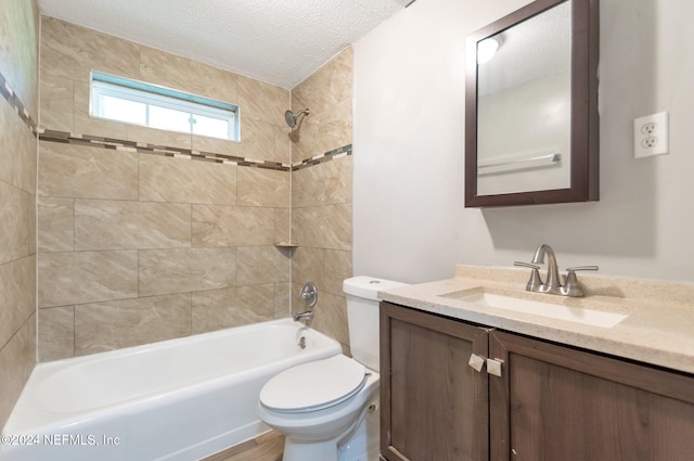 full bathroom with tiled shower / bath, a textured ceiling, wood-type flooring, toilet, and vanity