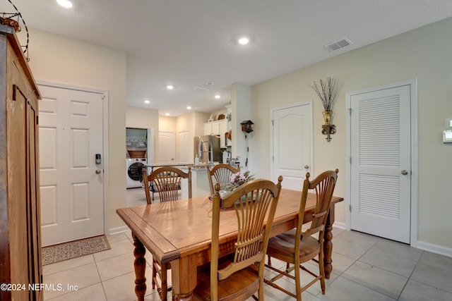 tiled dining space with washer / dryer