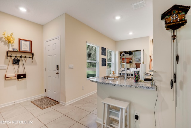 kitchen featuring light stone counters and light tile patterned floors