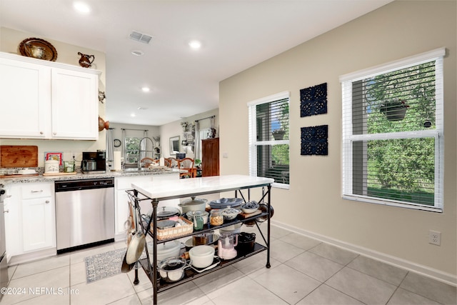 kitchen with white cabinets, a healthy amount of sunlight, and stainless steel dishwasher