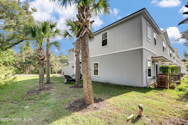 view of side of property featuring a yard