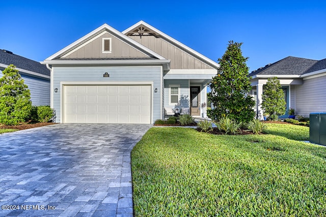 view of front of house featuring a garage and a front lawn