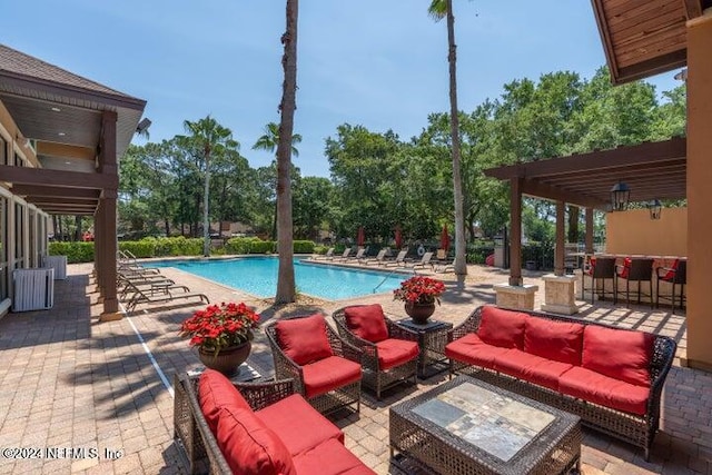 view of swimming pool with outdoor lounge area and a patio