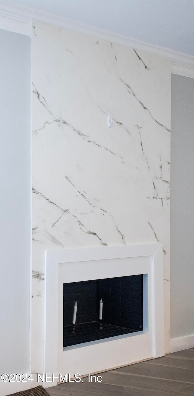 interior details featuring hardwood / wood-style floors and crown molding