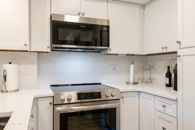 kitchen featuring appliances with stainless steel finishes and white cabinetry