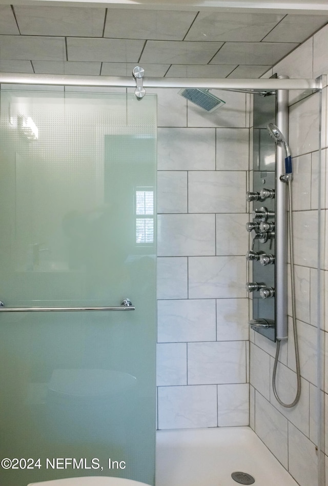 bathroom with a shower with shower door