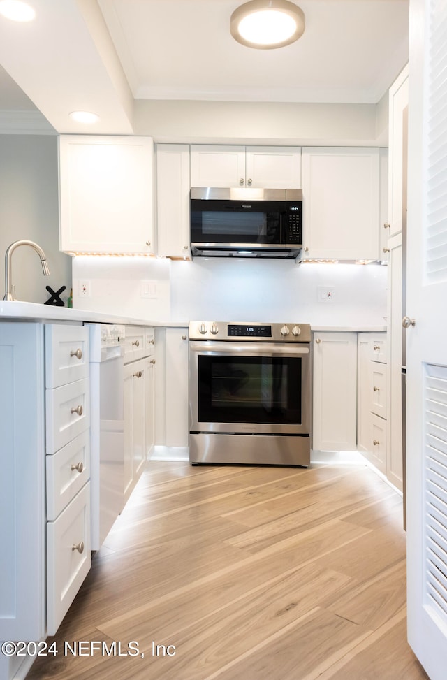 kitchen featuring light wood-type flooring, white cabinetry, and stainless steel appliances