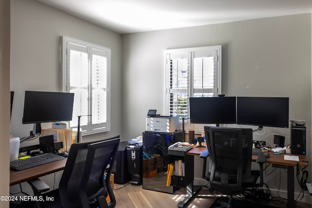 office with plenty of natural light and light hardwood / wood-style flooring