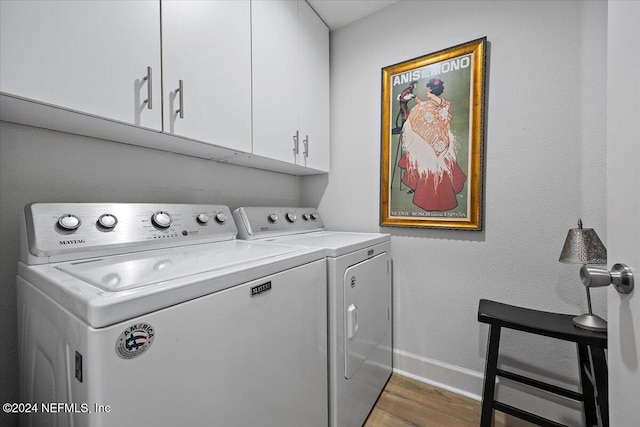 laundry area with separate washer and dryer, dark wood finished floors, cabinet space, and baseboards