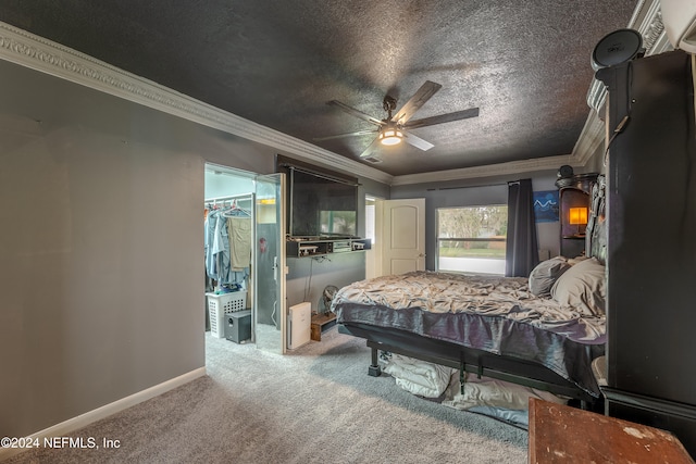 carpeted bedroom with a closet, a textured ceiling, ceiling fan, and crown molding