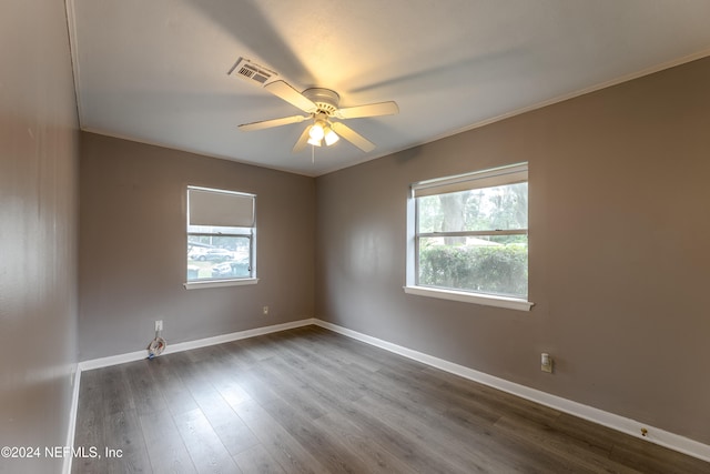 spare room featuring wood-type flooring, ceiling fan, and crown molding