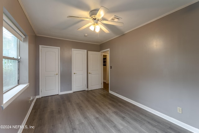 unfurnished bedroom with wood-type flooring, ceiling fan, and crown molding