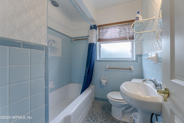 bathroom featuring toilet, tile walls, shower / bath combination with curtain, and tile patterned flooring