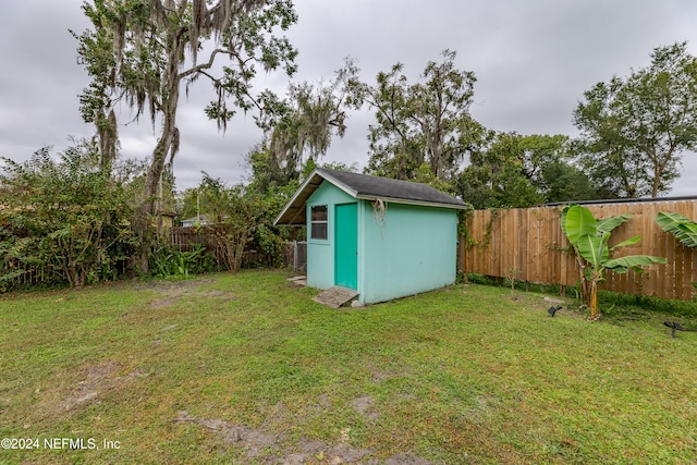 view of outbuilding with a yard