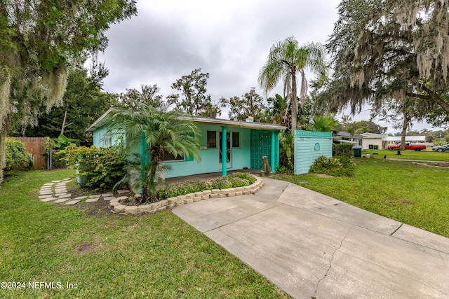 single story home with a front yard and covered porch