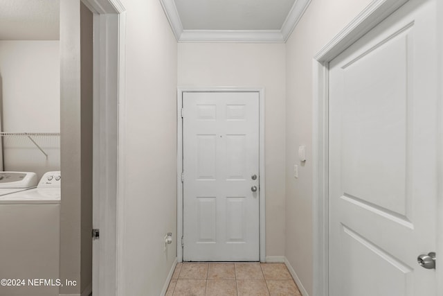 doorway featuring crown molding, washing machine and dryer, and light tile patterned floors