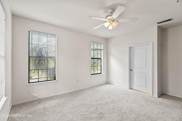 carpeted empty room with ceiling fan