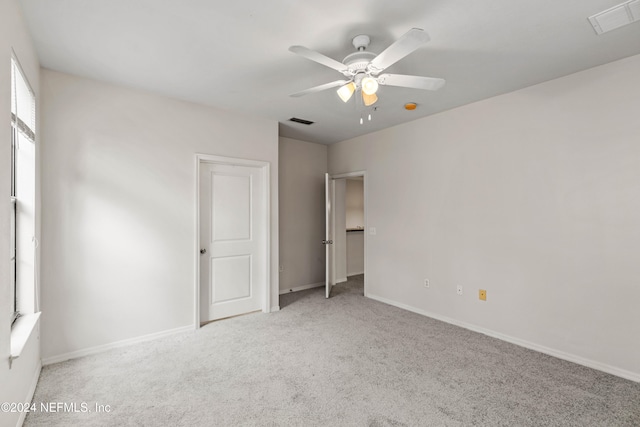 carpeted empty room featuring ceiling fan