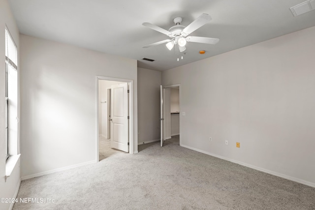 unfurnished bedroom with ceiling fan and light carpet