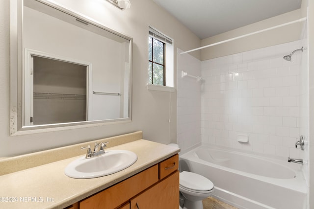 full bathroom featuring vanity, tiled shower / bath combo, toilet, and tile patterned flooring