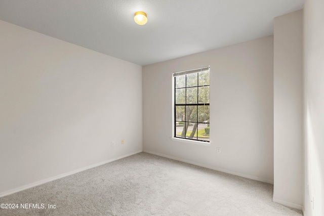 empty room featuring light colored carpet