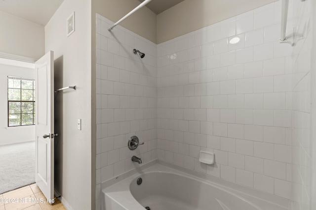 bathroom with tile patterned floors and tiled shower / bath combo