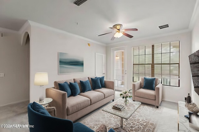 carpeted living room featuring crown molding and ceiling fan