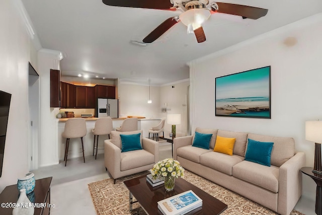 living room with crown molding and ceiling fan