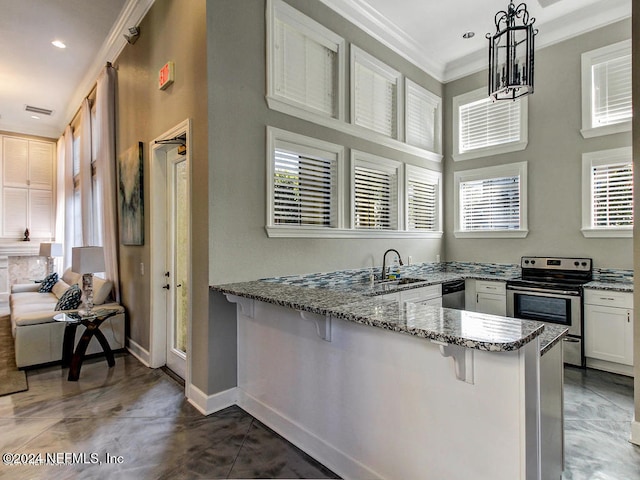 kitchen featuring kitchen peninsula, a breakfast bar, white cabinetry, pendant lighting, and stainless steel appliances