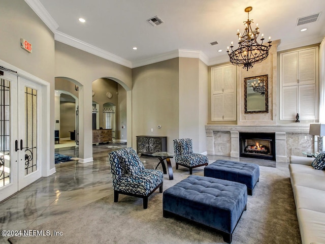 living room featuring french doors, crown molding, and a fireplace