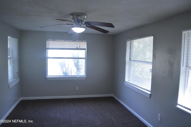 spare room featuring ceiling fan, a textured ceiling, and carpet floors