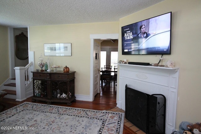 living room with hardwood / wood-style flooring and a textured ceiling