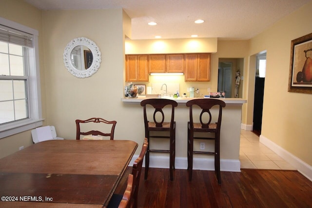 dining space featuring wood-type flooring and sink