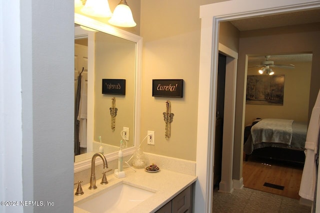 bathroom featuring vanity, hardwood / wood-style flooring, and ceiling fan