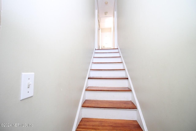 staircase featuring hardwood / wood-style flooring