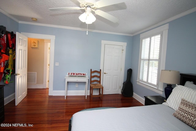 bedroom with ornamental molding, dark wood-type flooring, a textured ceiling, and ceiling fan