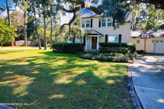 view of front of property with a front yard and a garage