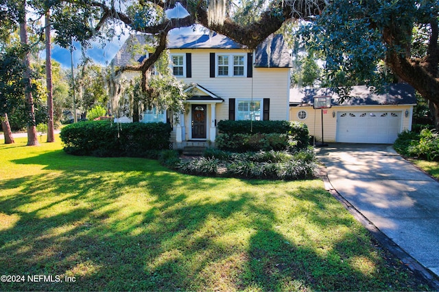 view of front of home with a front yard and a garage