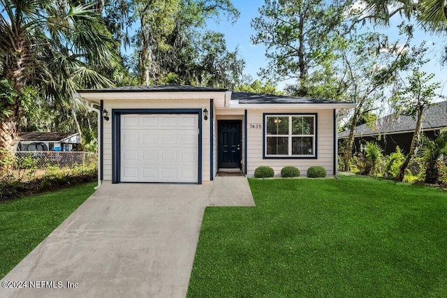 single story home with a front yard and a garage