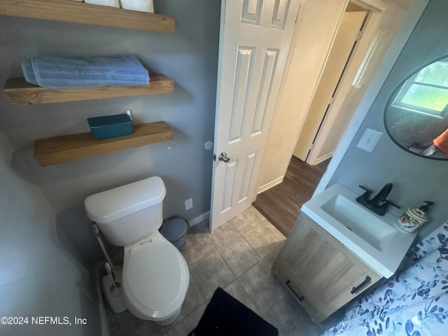 bathroom with vanity, toilet, and tile patterned flooring