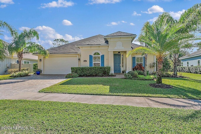 136 Pescado Dr, Saint Augustine, FL 32095 - mediterranean / spanish house with stucco siding, a garage, driveway, a front yard, and a shingled roof