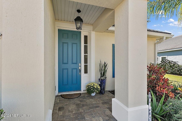 136 Pescado Dr, Saint Augustine, FL 32095 - doorway to property featuring stucco siding