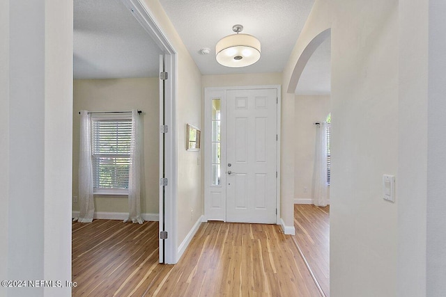 entryway featuring light hardwood / wood-style flooring and a textured ceiling