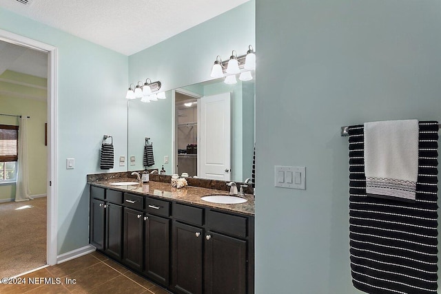 bathroom with vanity, tile patterned floors, and a textured ceiling