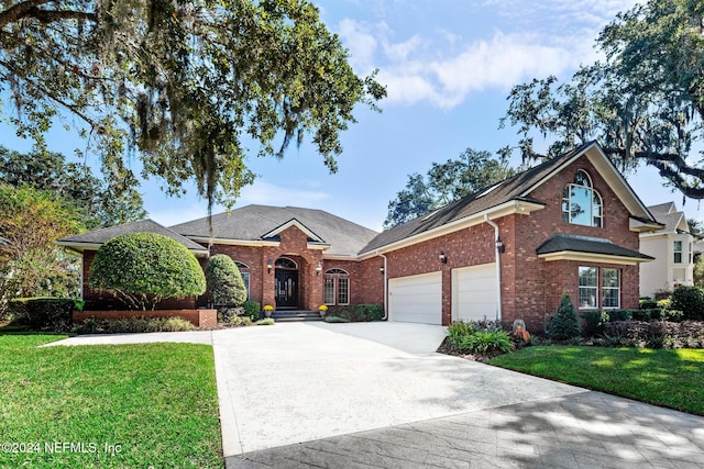 view of front of property with a garage and a front yard